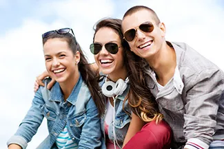 Three teenagers smiling