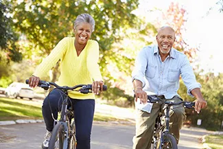 A couple riding bikes on a nice day