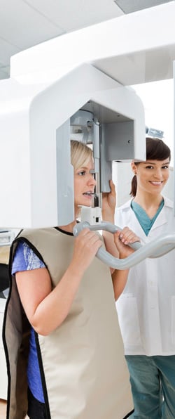 A patient getting a panoramic x-ray of her jaw